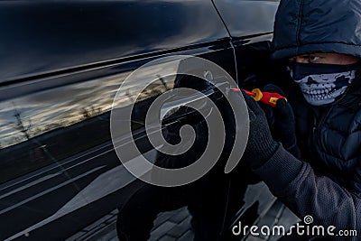 Attempted car theft using a suitcase in the city center Stock Photo