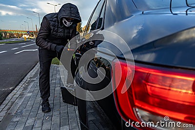 Attempted car theft using a suitcase in the city center Stock Photo