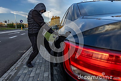 Attempted car theft using a suitcase in the city center Stock Photo
