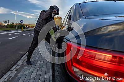 Attempted car theft using a suitcase in the city center Stock Photo