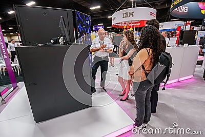 Attendees listen stand-attendant at Intel booth of exhibition Editorial Stock Photo