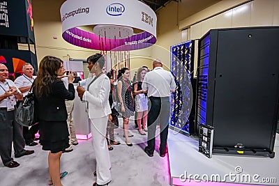 Attendees listen stand-attendant at Intel booth of exhibition Editorial Stock Photo