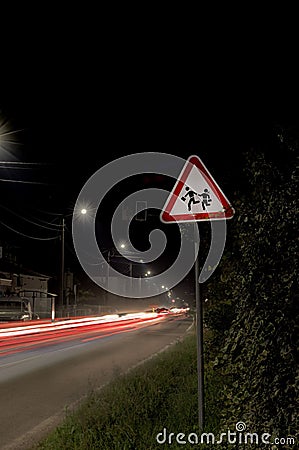 Attention children street sign at night Stock Photo