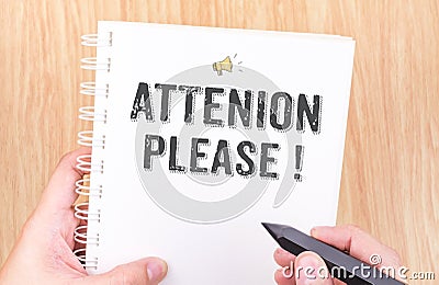 Attention please! word on white ring binder notebook with hand h Stock Photo