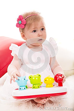 Attentive baby girl looking away Stock Photo
