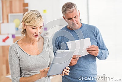 Attentive business colleagues reading and using tablet Stock Photo