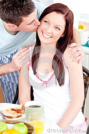Attentive businessman kissing his girlfriend Stock Photo