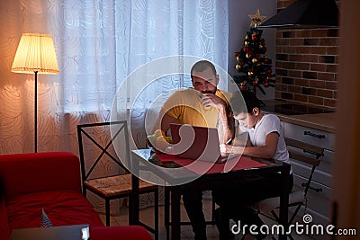 Attentive and careful father help son to study Stock Photo