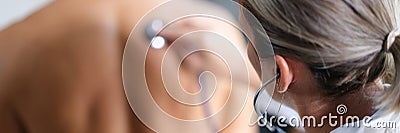 Attentive doctor checks lungs of patient with stethoscope Stock Photo