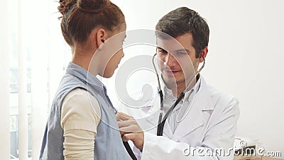 The attentive doctor listens to the lungs of a small patient with a stethoscope Stock Photo