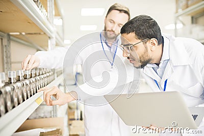 Attentive engineers viewing pressure transducers Stock Photo