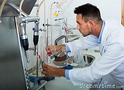 attentive man making tests in wine manufactory laboratory Stock Photo