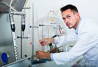 Attentive man making tests in wine manufactory laboratory Stock Photo