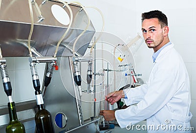 Attentive man making tests in wine manufactory laboratory Stock Photo