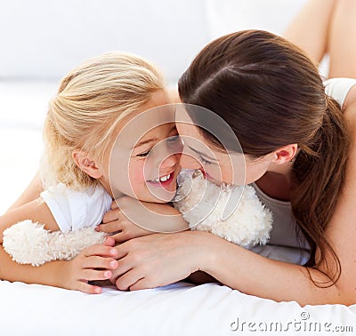 Attentive mother hugging her daughter Stock Photo