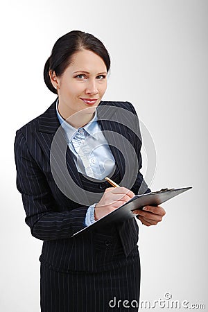 Attentive office worker writing in the folder. Stock Photo