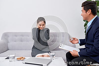 Attentive psychologist. Attentive psychologist holding pencil in his hands making written notes while listening to his client Stock Photo