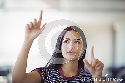 Attentive schoolgirl gesturing in classroom Stock Photo