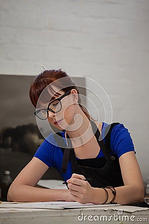 Attentive woman sketching in drawing book Stock Photo