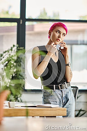 attentive young female worker with pink Stock Photo