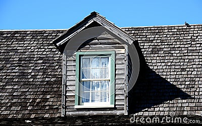 Attic window in tiled roof Stock Photo