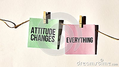 ATTITUDE CHANGES EVERYTHING text words inscription on yellow sticker note on white wall or table Stock Photo