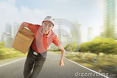 Attractive asian courier delivering package Stock Photo