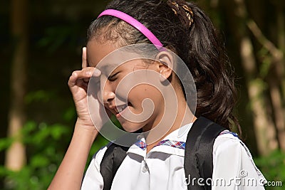 Cute Minority School Girl Thinking With Books Stock Photo