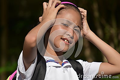Forgetful Minority Female Student With Books Stock Photo