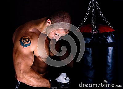 Attractive athletic young man training kickboxing Stock Photo