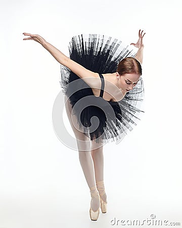 Attractive ballerina stands on her fingertips. photo shoot in the studio on a white background Stock Photo