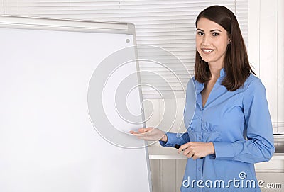 Attractive beautiful business woman before a flip chart. Stock Photo