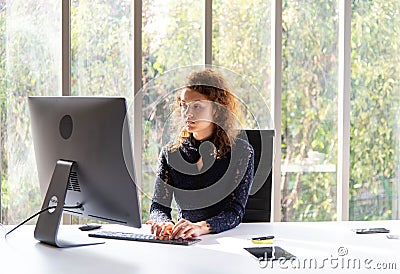 Attractive beautiful business woman working with computer in the modern office or home Stock Photo