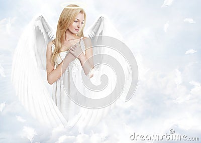 Attractive blond angel in sky Stock Photo