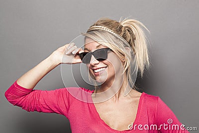 Attractive blond lady with raybans smiling Stock Photo