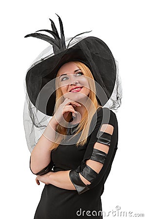 Attractive blond woman with green eyes looks up in black witch hat. Young witch, vertical frame. Halloween party, white background Stock Photo