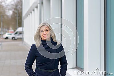 Attractive blond woman in a stylish blue coat Stock Photo