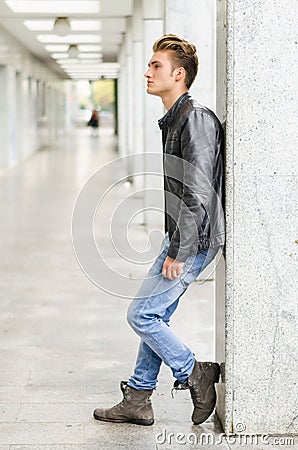 Attractive blond young man standing outside Stock Photo