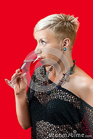Attractive blonde girl holding glass of red wine Stock Photo