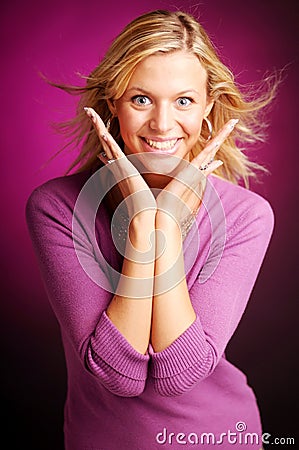 Attractive blonde woman in violet sweater Stock Photo