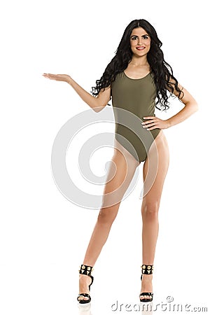 Attractive brunette advertizing in one piece swimsuit Stock Photo