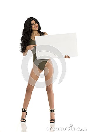 Attractive brunette with blank board in one piece swimsuit on white Stock Photo