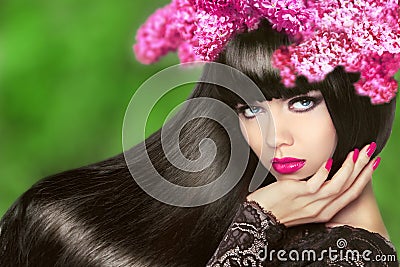 Attractive Brunette Girl with Flowers Long Hair. Healthy Black H Stock Photo