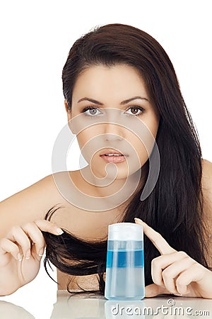 Attractive brunette woman keeps flacon by arms Stock Photo