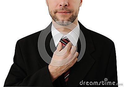 Attractive business man straightens his tie Stock Photo