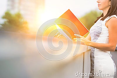 Attractive business woman reads real file outside, concept moden women working in business Stock Photo