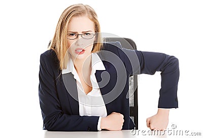 Attractive business woman by the table, bossy behaviour. Stock Photo