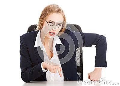 Attractive business woman by the table, bossy behaviour. Stock Photo