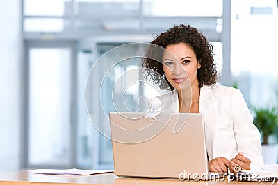 Attractive business woman working on laptop Stock Photo