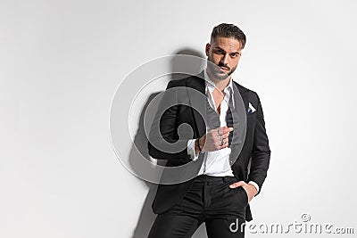 Attractive businessman arranging his undone bowtie Stock Photo